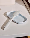 A GIR Studio Spatula resting on a light blue tray. 