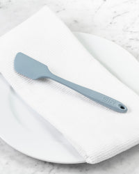The Slate Spatula resting on a Onsen Waffle Hand Towel.