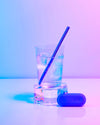 The GIR Straw in a glass of Ice water on a colorful background.