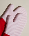 Close up of the Red Oven Mitts on a cream background.