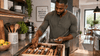 A black man organizing the utensil drawer,