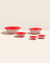 The Red 5 Piece Suction Lid set covering glass bowls on a cream background. 