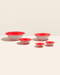 The Red 5 Piece Suction Lid set covering glass bowls on a cream background. 