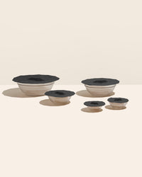 GIR 10 Piece Black Suction Lids on a cream background. 