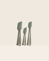 The GIR Sage Green 3 Piece Spatula Set on a pink background. 