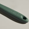 The GIR Sage Green Spoon handle on a grey background.
