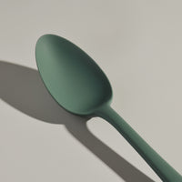 The GIR Sage Green Spoon on a grey background.