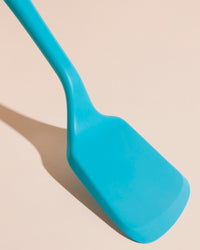 Close-up image of the GIR Flip in Teal on a cream background.