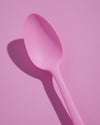 Close up of the Summer Set Pink Spoon on a Pink background. 