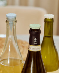 Close up of the Celebration Bottle Stoppers on wine bottles. 