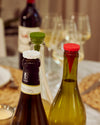 Close up of the Holiday Bottle Stoppers on wine bottles. 