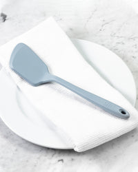 The Slate Mini Flip on a White towel and plate. 