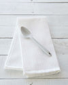 The Studio Mini Spoon on a white towel. 