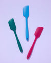 The Ruby, Emerald and Blue Teal Spatula on a purple background. 