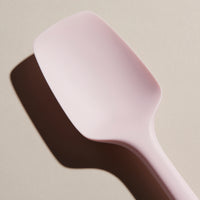 Close up of the Light Pink Spoonula on a cream background. 