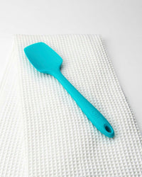 The Teal Spoonula on an Onsen Towel on a white background. 