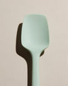A close up of the Mint Spoonula on a cream background. 