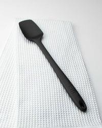 The Black Skinny Spoonula on an Onsen Waffle Hand Towel. 