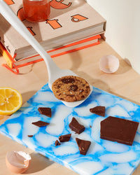 The GIR Studio Ultimate Flip with a cookie on it with chocolate, half a lemon and eggshells around it. 