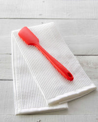 The Red Ultimate Spatula on an Onsen Waffle Towel. 