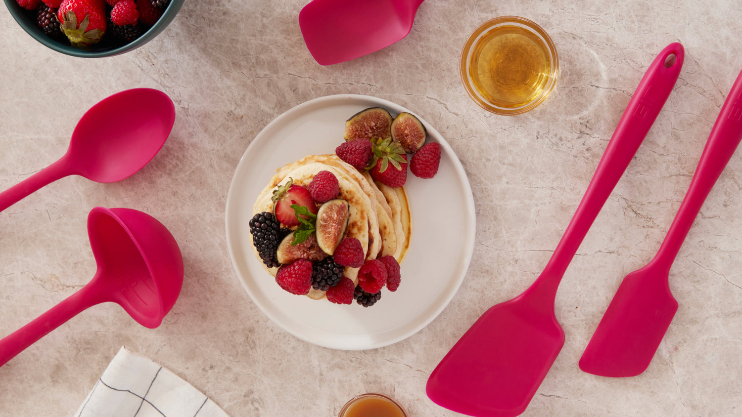 Over head shot of the Ruby GIR tools, with a plate of Pancakes and fruit on a marble background. 
