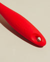 Close-up image of the GIR Red Quad Chopper handle on a cream background.
