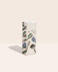 Box of silicone spoons with a beige background