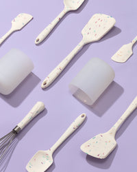 The GIR Sprinkle 4 Piece Mini Tool & Container Set laid out on a grey background. 