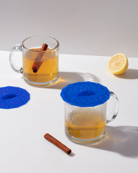 The GIR Suction Lids used to cover glass mugs on a table setting. 