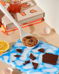 The GIR Studio Ultimate Flip with a cookie on it with chocolate, half a lemon and eggshells around it. 