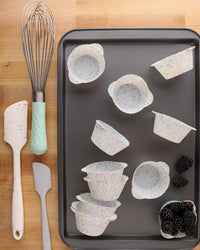 The GIR Confetti Cupcake Bundle displayed with a Mini Spatula and a baking tray.