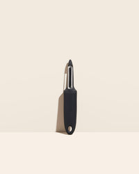  The I Handle Serrated Peeler in Black on a cream background. 