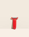 The Y Handle Julienne Peeler in Red on a cream background. 