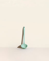 The Mint Skinny Ladle on a cream background. 