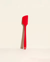 The Red Pro Spatula on a cream background. 