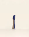 The Navy Ultimate Spatula on a cream background. 