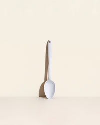 The Studio Ultimate Spoon on a Cream Background. 