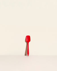 The Red Mini Spoonula on a cream background. 