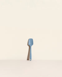 The Slate Mini Spoonula on a cream background. 