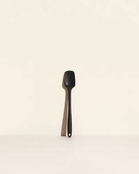 The Black Skinny Spoonula on a cream background. 