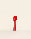 The Red Ultimate Spoonula on a cream background. 