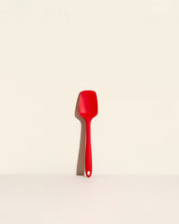 The Red Ultimate Spoonula on a cream background. 