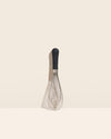 The Black Ultimate Whisk on a cream background. 