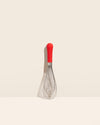 The Red Ultimate Whisk on a cream background. 