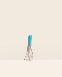 The Sea Foam Mini Whisk on a cream background. 