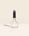 The GIR Wired Masher in Black on a cream background. 