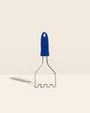 The GIR Wired Masher in Royal Blue on a cream background. 