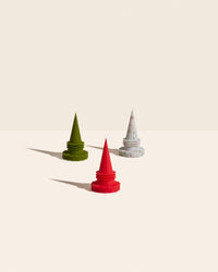 The Holiday Bottle Stoppers pointed up on a cream background. 