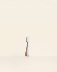 The Sprinkle Mini Spatula on a cream background. 