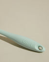 Close-up image of the GIR Mint Quad Chopper handle on a cream background.